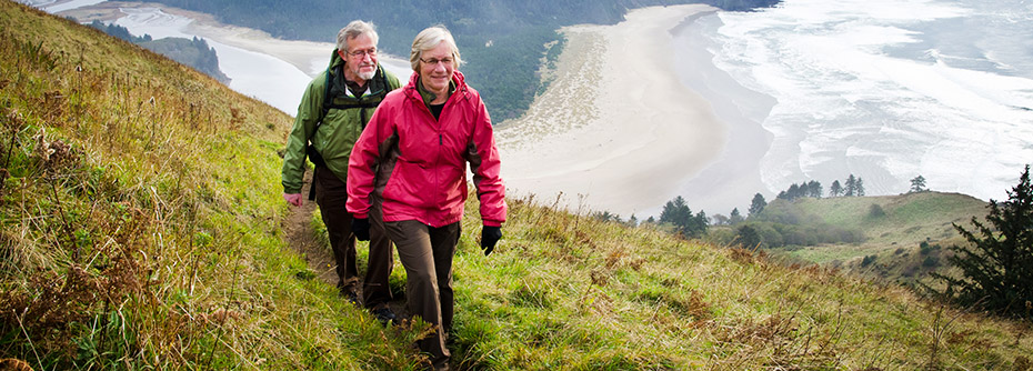 Stock photo of two people walking up a hill on a scenic hike