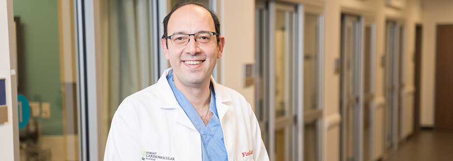 Dr. Firas Zahr standing in a hospital hallway smiling.