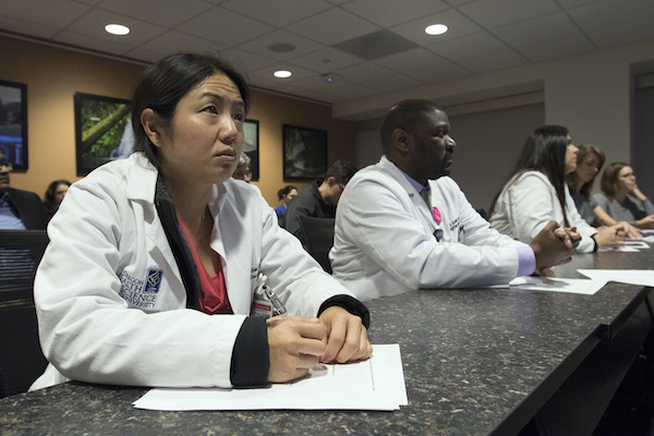 Dr. Christina Sayama (left) and Dr. Jerry Jaboin join a Pediatric Brain Tumor Board, where doctors from a range of specialties gather to combine their expertise for patients