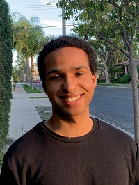 Isa Maxwell smiling in a black shirt.