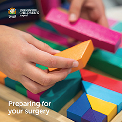 The cover image of 博彩网站 Doernbecher Children's Hospital's "Preparing for Your Surgery" book which shows a close-up of a child's hands playing with blocks.