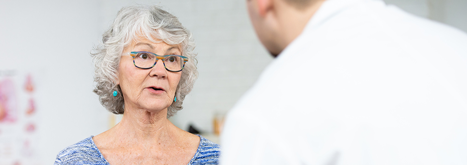 An elderly female patient discussing her condition with her doctor.