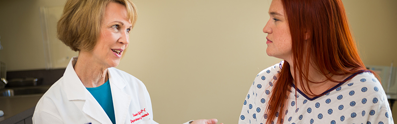 A care provider chats with an eczema patient