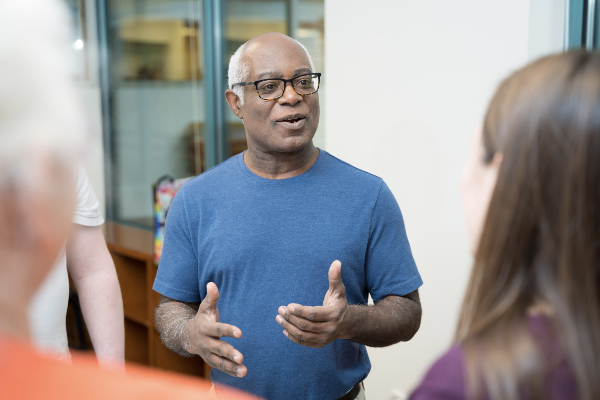 Older man discussing diabetes with other participants in class