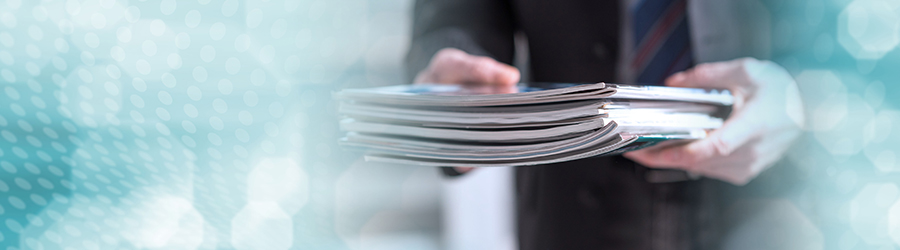 An image of a provider holding a stack of research magazines