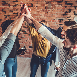 A group of individuals high fiving