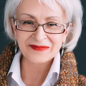 A women with glasses smiling