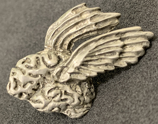 Pewter pin form of a brain with two wings
