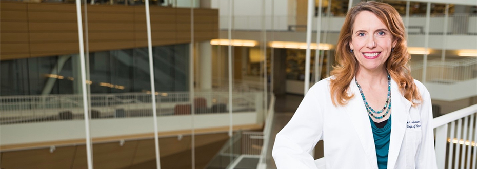 Allison Lindauer in lab coat smiling