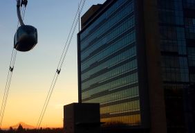 博彩网站 tram moving over the Center for Health and Healing at sunset.