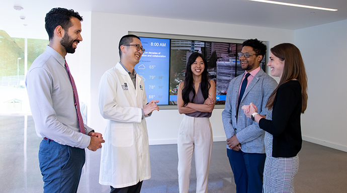 Residency Program Director Dr. Dan Tu stands with four residents at 博彩网站.