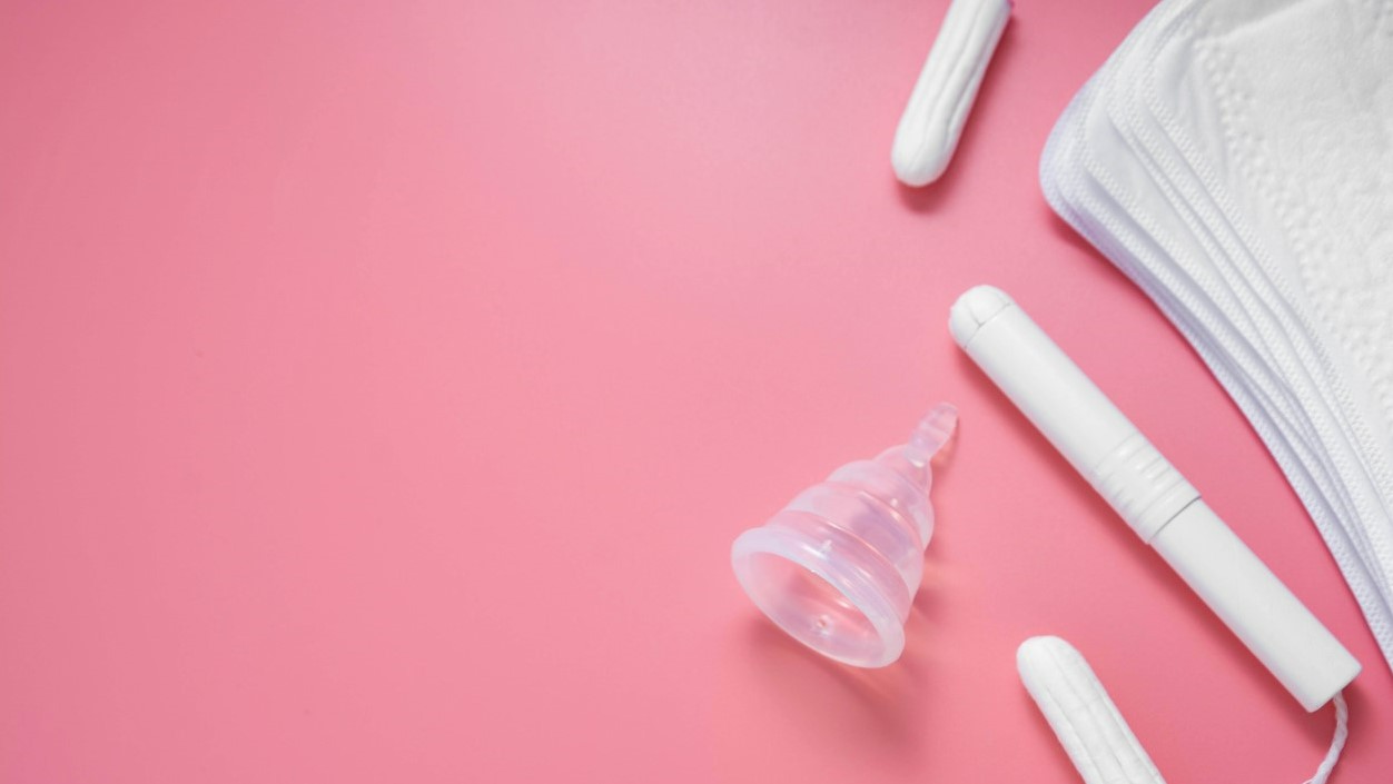 Collection of menstrural products on pink background