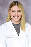 Doctor Jennifer Strunck smiles in her white coat