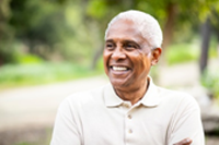 older man smiling outdoors