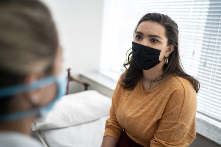 A pregnant patient talking with a healthcare provider.