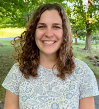 Graduate Student Katie Emberley, posed outdoors, smiling