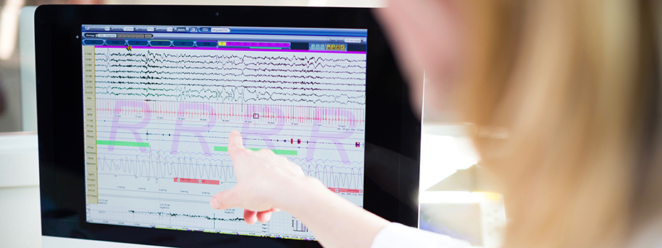 A sleep disorders researcher studies brain waves and sleep data