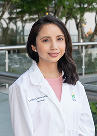 Carolina Garcia Garcia, D.O., M.S., MS fellow, posed smiling in her white coat