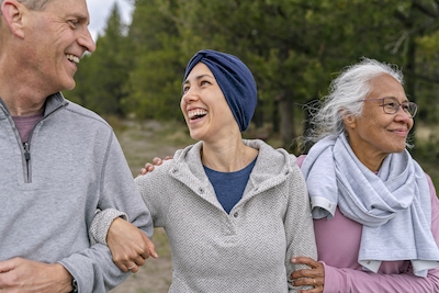 Three people walking outside together.