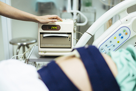 Close-up of a fetal monitor machine tracking a baby’s heart rate.