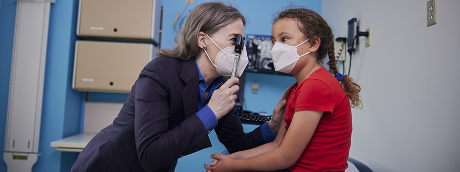 Dr. Collins closely examines a patient’s eyes.