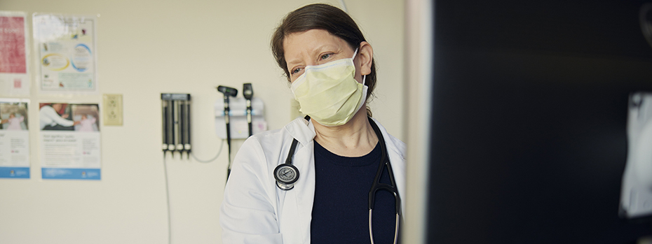 Dr. Bohun smiles at a patient during an exam.
