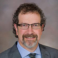 A professional photo of Dr. Miles Ellenby.