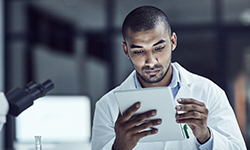 A male researcher reviewing data in a laboratory.