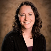 Smiling woman with brown curly hair