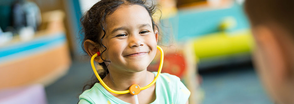 A child wearing a toy stethoscope.