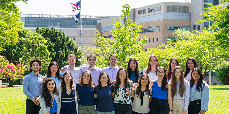 The PGY-1 Pediatric Residency Class standing outside with 博彩网站 Hospital behind them on a sunny day.