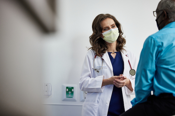 Dr. Alexandra Sokolova meets with a patient in a clinic.