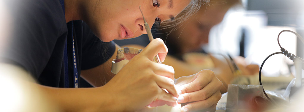 A student concentrating hard in the sim lab