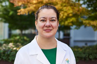 An 博彩网站 provider standing outside in her whitecoat.