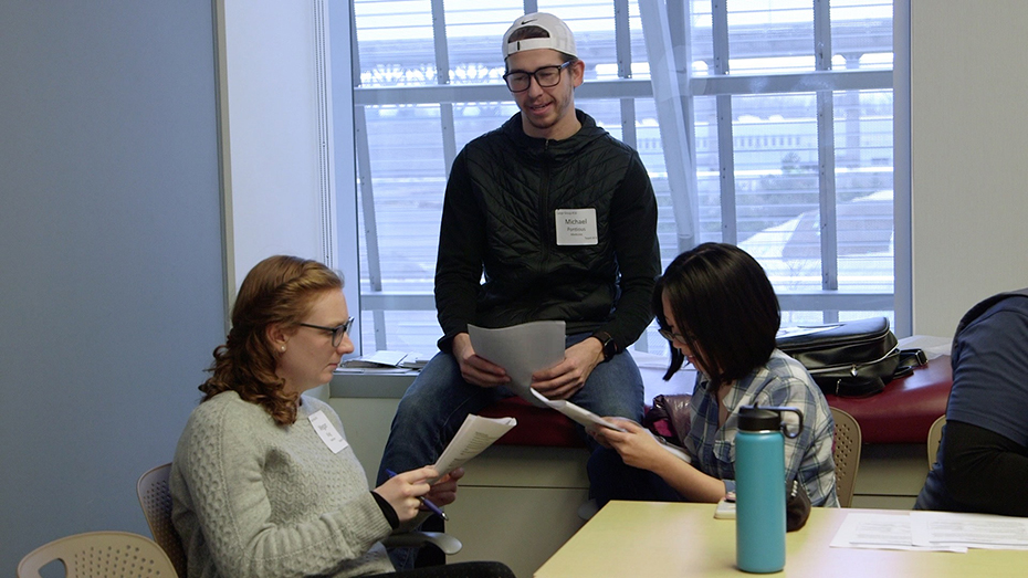Three IPE Foundations students having a group discussion.
