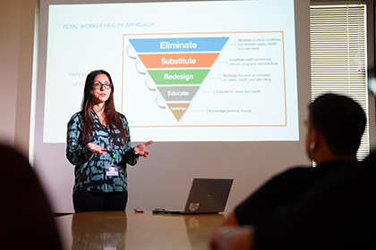 Dr. Katia Costa-Black giving a total worker health presentation.