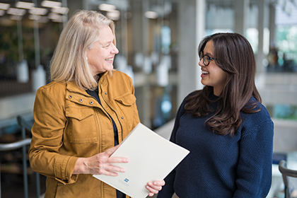 Outreach team members walking together in a library.
