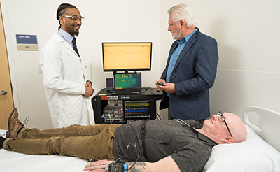 Professor Steve Shea working in the sleep lab with mentees.
