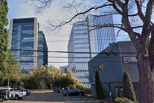 parking lot with 2 skyscrapers behind it parking lot with 2 skyscrapers behind it