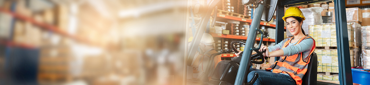 Portrait of a woman working with a forklift in a warehouse