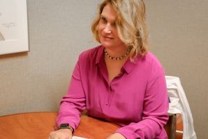 Dr. Maria I. Rodriguez sits at a table in the Center for Women's Health.