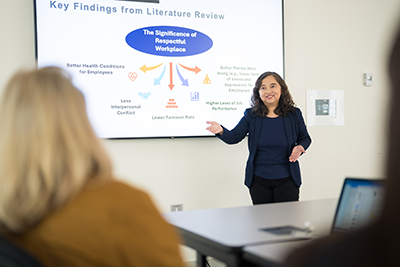 Professor Emily Huang presenting on the respectful workplace initiative.