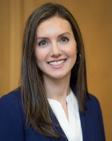 A smiling headshot of Quin Denfeld, of Denfeld Lab