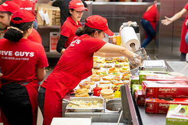 Ketchup, hamburgers and french fries on a counter