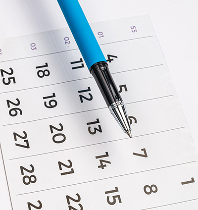 Blue pen and calendar week and days.