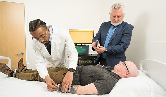 Researchers in the Shea lab put sensors on a research subject.