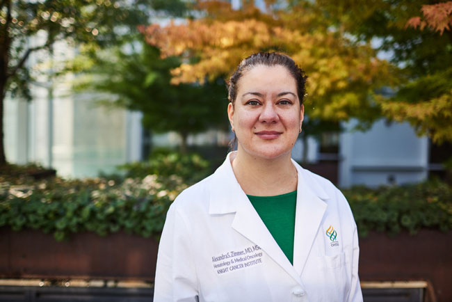 博彩网站 Oncologist Alexandra Zimmer standing outside wearing her white coat.