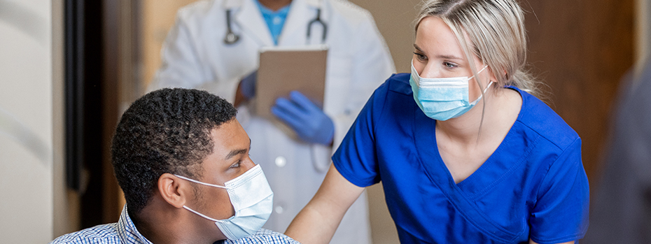 Nurse talking to male patient.