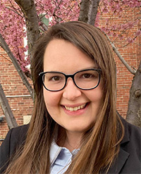 Alicia Dupre outdorrs headshot in front of tree with fall leaves