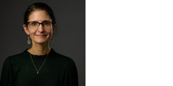 smiling woman wearing glasses and dark brown sweater